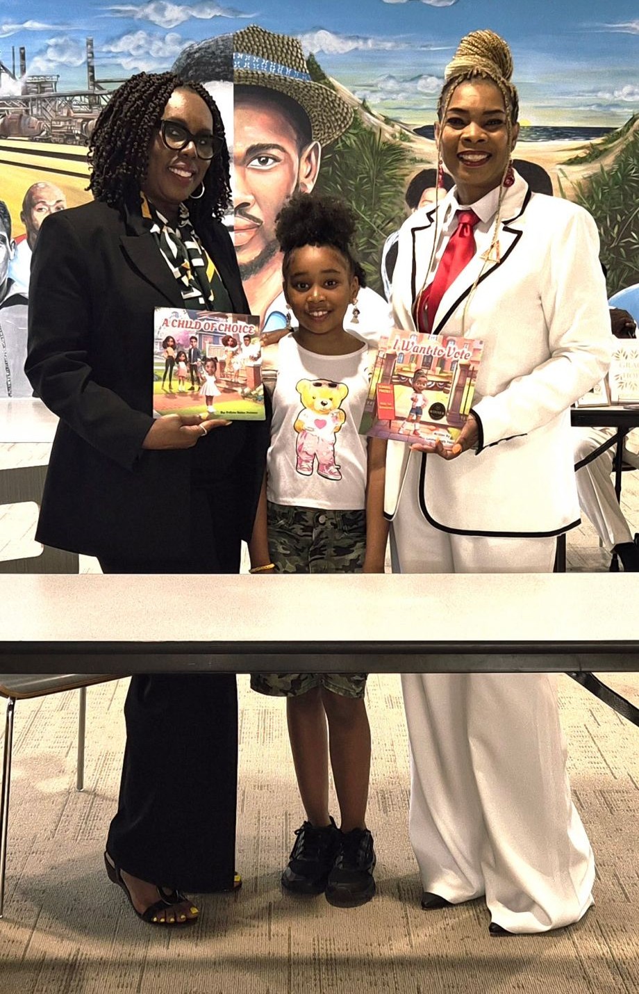 Readers holding A Child of Choice and I Want to Vote at a book event